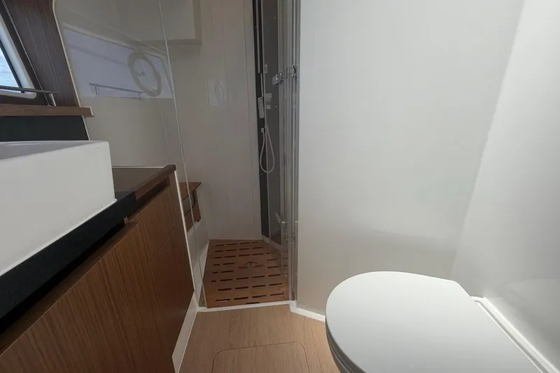 Slide: The Image of Modern bathroom interior of 2022 Sealine C430 yacht with shower and wooden accents. - 82