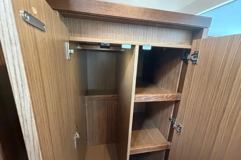 Slide: The Image of Wooden cabinet interior with shelves in a 2022 Sealine C430 yacht. - 86