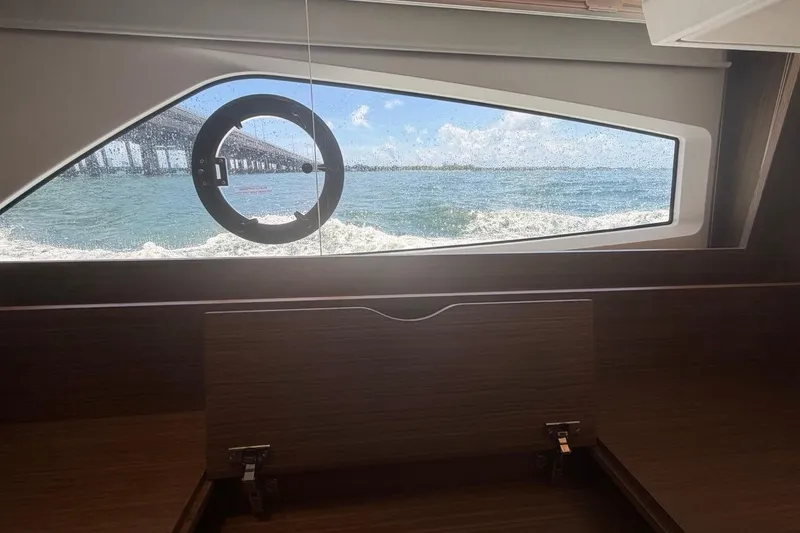 Slide: The Image of Interior view from a 2022 Sealine C430 yacht, showcasing ocean and bridge through a window. - 87