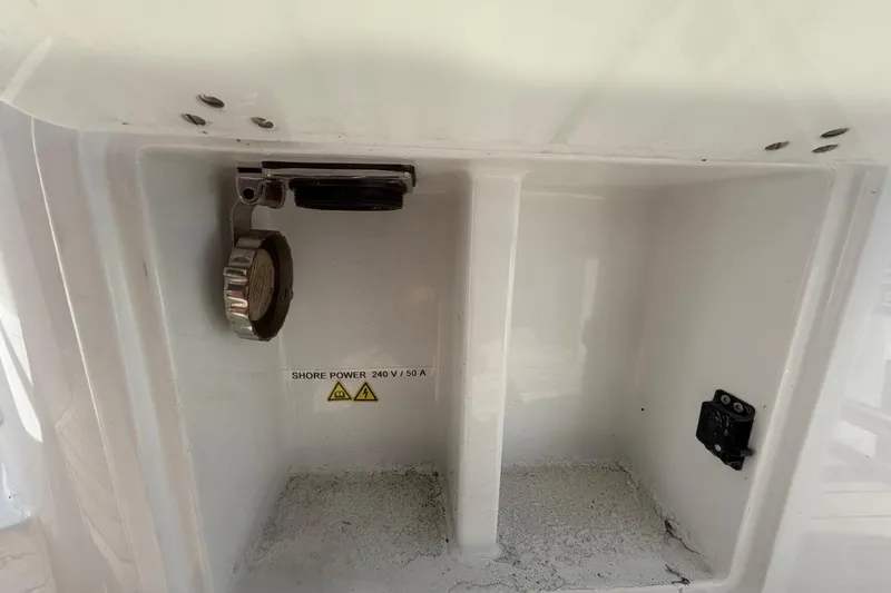 Slide: The Image of Sealine C430 2022 shore power connection, 240V/50A, in a white compartment. - 89