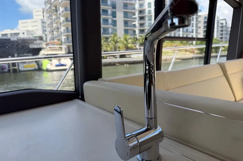 Slide: The Image of Interior of 2022 Sealine C430 yacht with chrome faucet and marina view. - 93