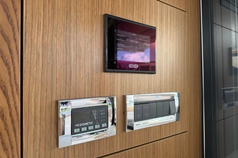 Slide: The Image of Control panel on 2022 Sealine C430 yacht with wood finish and digital displays. - 94