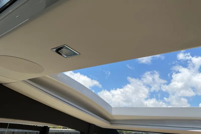 Slide: The Image of Sealine C430 2022 yacht interior with open sunroof and blue sky view. - 98