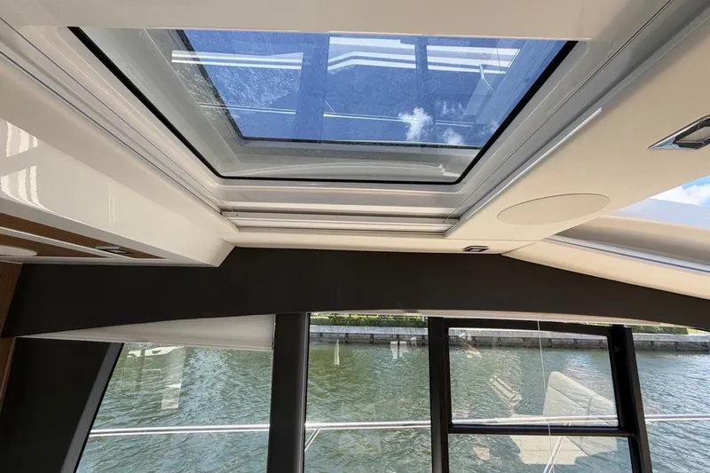 Slide: The Image of Interior view of 2022 Sealine C430 yacht with panoramic sunroof and water backdrop. - 99
