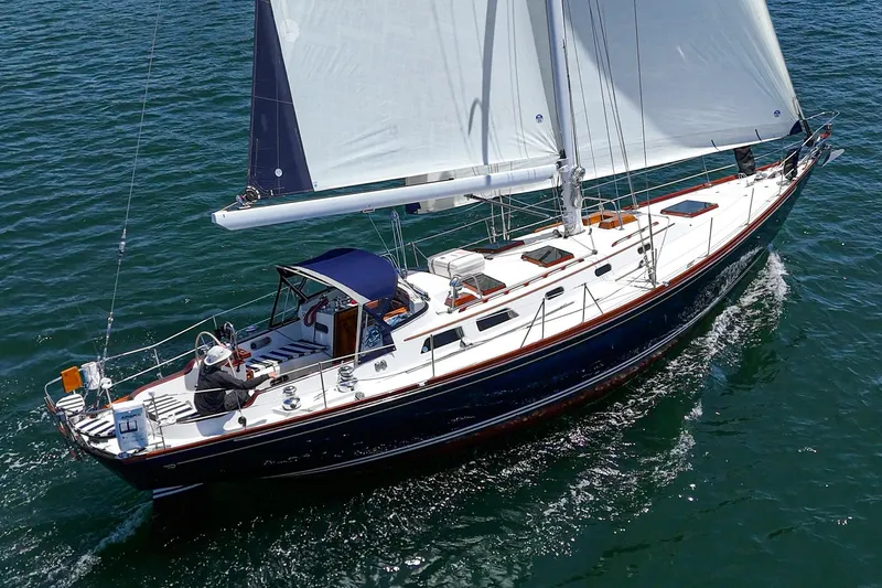 The Image of Sailing on open water, 1998 Hinckley Sou'wester 52 yacht with white sails and sleek design. - 1