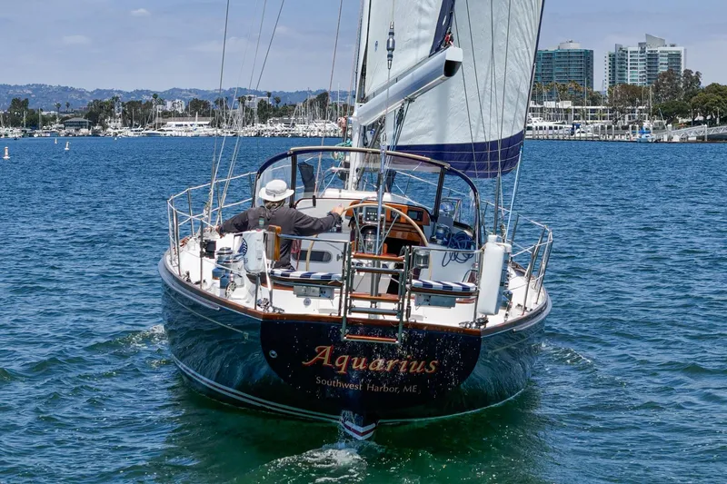 Slide: The Image of Sailing yacht Hinckley Sou'wester 52, 1998 model, cruising in a marina with cityscape backdrop. - 16
