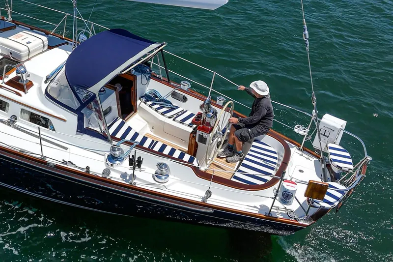 Slide: The Image of Sailing on a 1998 Hinckley Sou'wester 52 yacht with striped seating and blue canopy. - 18