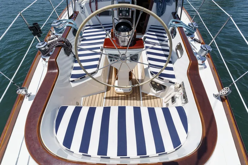 Slide: The Image of Cockpit of 1998 Hinckley Sou'wester 52 sailboat with striped cushions and wooden accents. - 20