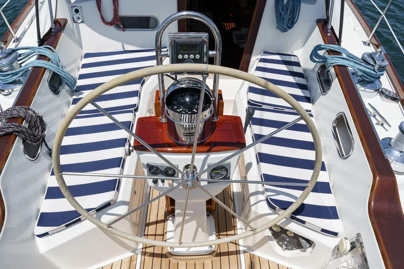 Slide: The Image of Cockpit of 1998 Hinckley Sou'wester 52 sailboat with striped seating and steering wheel. - 21