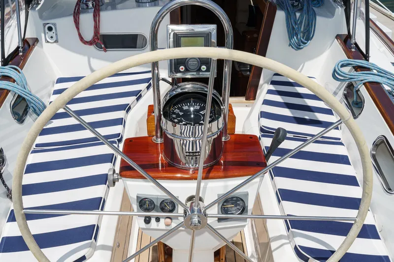 Slide: The Image of Cockpit of 1998 Hinckley Sou'wester 52 sailboat with striped cushions and navigation instruments. - 22