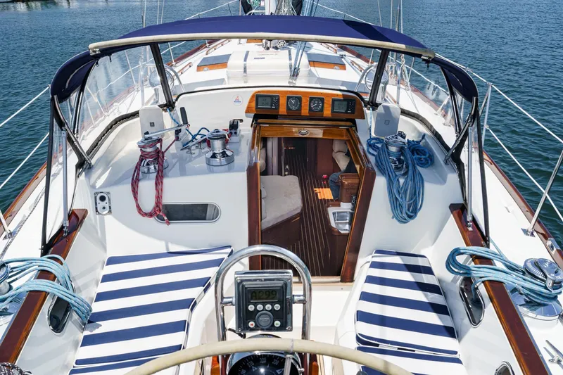 Slide: The Image of Cockpit of 1998 Hinckley Sou'wester 52 sailboat with striped seating and nautical equipment. - 24