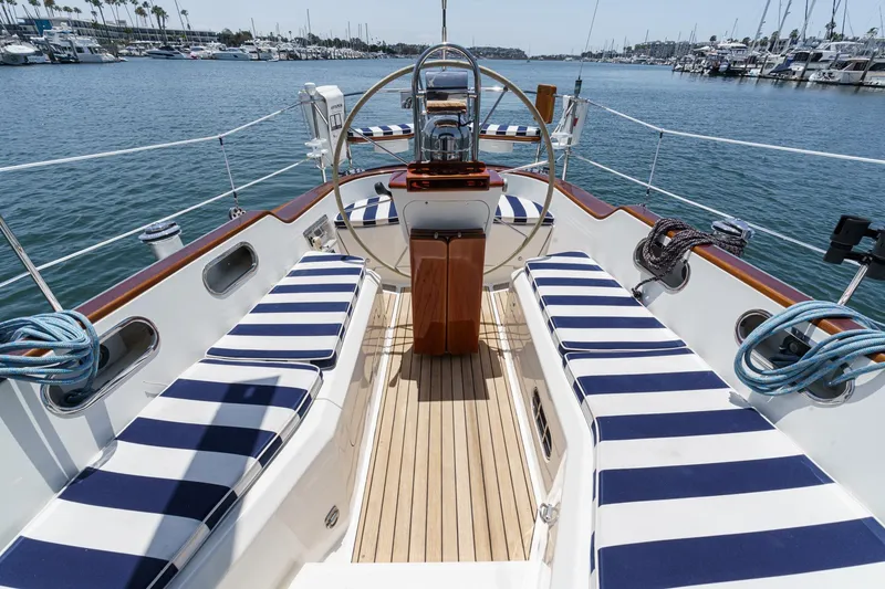 Slide: The Image of Cockpit of 1998 Hinckley Sou'wester 52 sailboat with striped cushions, docked in marina. - 29