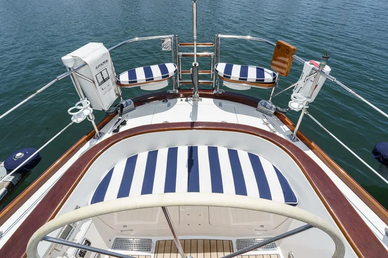 Slide: The Image of Hinckley Sou'wester 52 yacht deck with striped cushions, 1998 model, on calm water. - 30