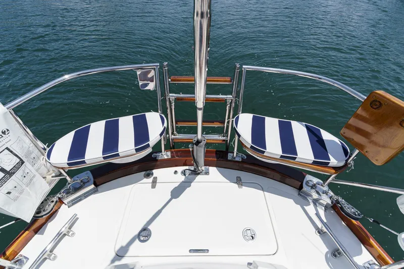Slide: The Image of Hinckley Sou'wester 52 sailboat deck with striped cushions, 1998 model, overlooking water. - 31