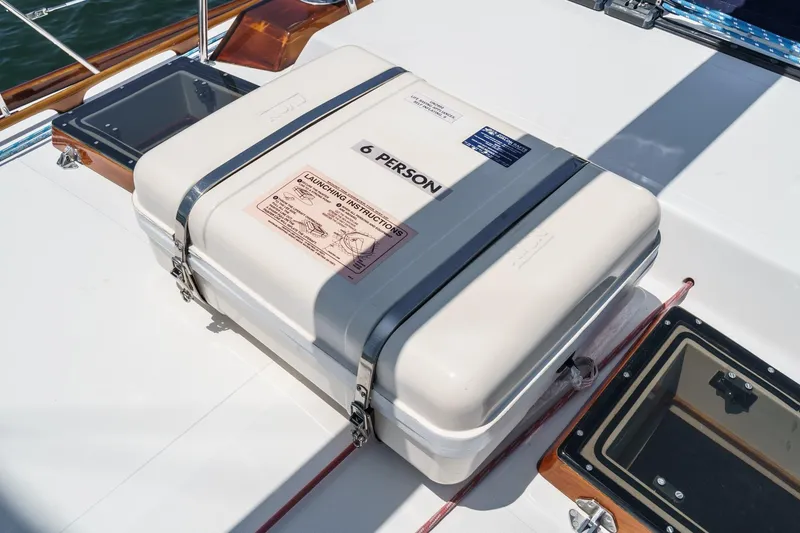 Slide: The Image of Life raft container on 1998 Hinckley Sou'wester 52 yacht deck, labeled for six people. - 38