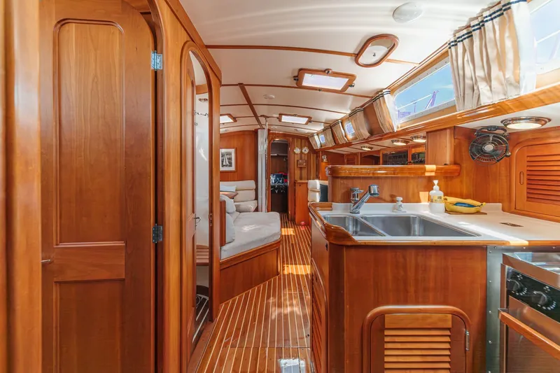 Slide: The Image of Interior of 1998 Hinckley Sou'wester 52 yacht, featuring elegant wood finishes and modern amenities. - 44