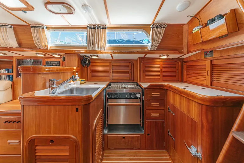 Slide: The Image of Luxurious wooden interior of a 1998 Hinckley Sou'wester 52 yacht kitchen with modern amenities. - 46