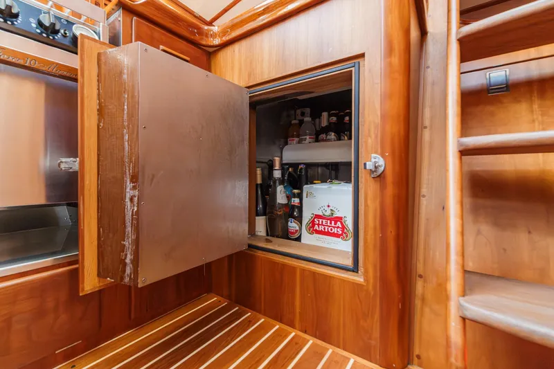 Slide: The Image of Wooden interior of 1998 Hinckley Sou'wester 52 yacht with open fridge stocked with beverages. - 51