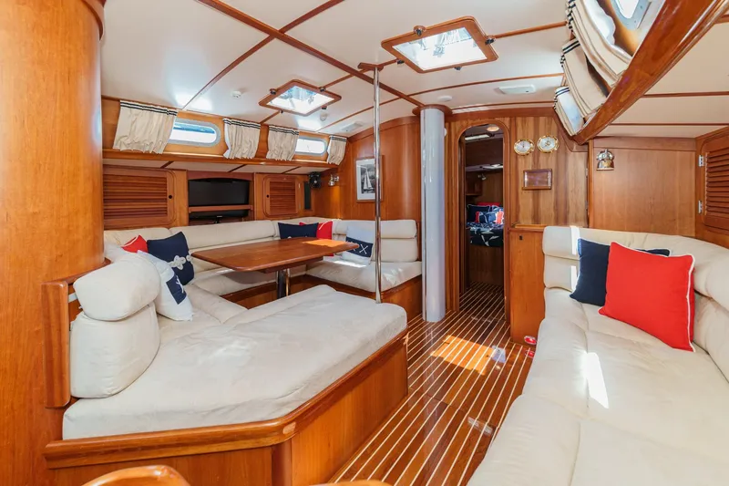 Slide: The Image of Luxurious interior of 1998 Hinckley Sou'wester 52 yacht with elegant wood finish and plush seating. - 54