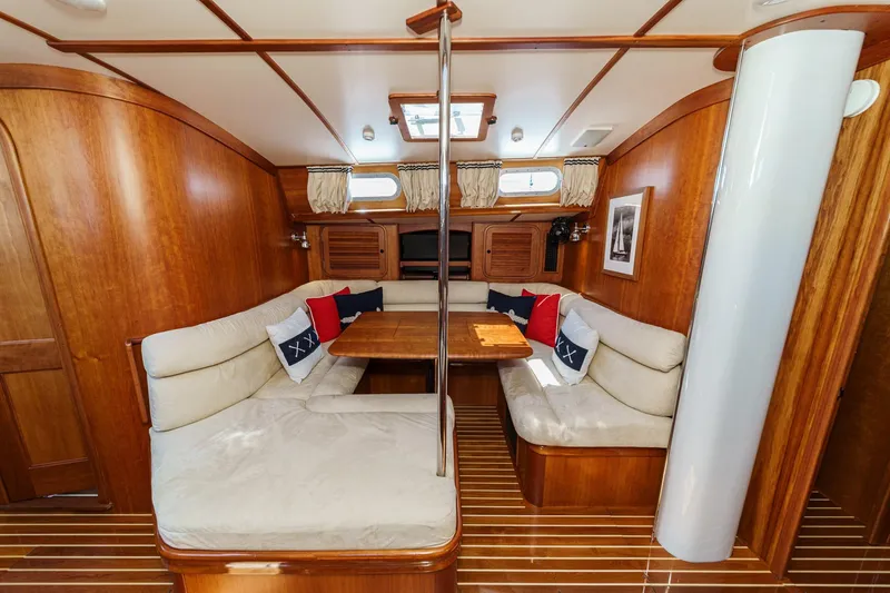 Slide: The Image of Interior of 1998 Hinckley Sou'wester 52 yacht with wooden finish and cozy seating area. - 56