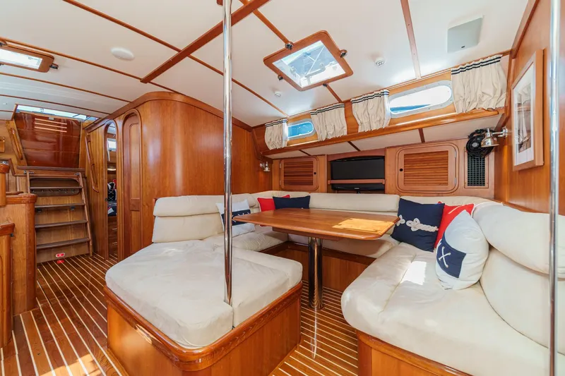 Slide: The Image of Luxurious interior of 1998 Hinckley Sou'wester 52 yacht with wooden finishes and cozy seating. - 57