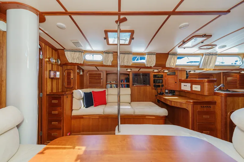 Slide: The Image of Luxurious interior of 1998 Hinckley Sou'wester 52 yacht with wood finish and cozy seating. - 58