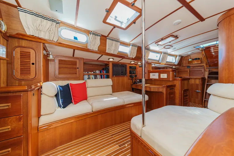 Slide: The Image of Interior of 1998 Hinckley Sou'wester 52 yacht, featuring elegant wood finish and cozy seating. - 59