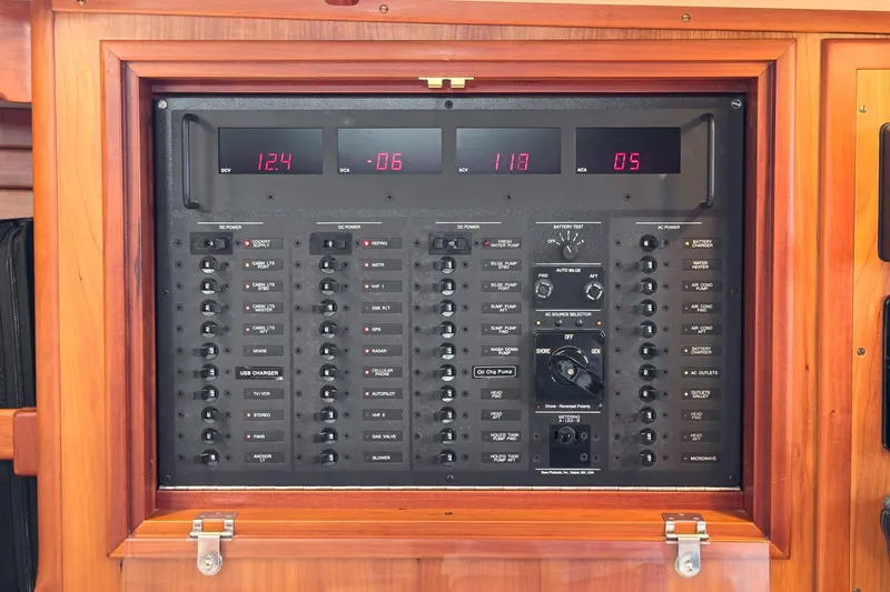 Slide: The Image of Electrical control panel on a 1998 Hinckley Sou'wester 52 yacht, featuring various switches and displays. - 63