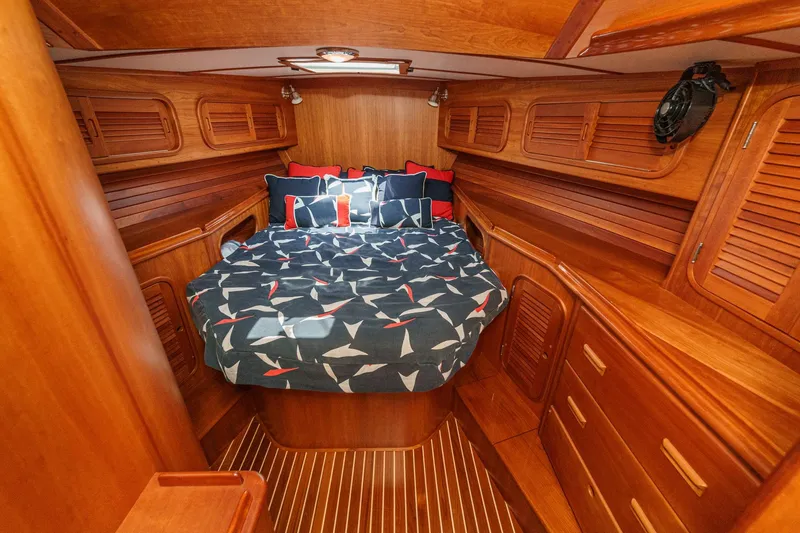 Slide: The Image of Luxurious wooden cabin interior of 1998 Hinckley Sou'wester 52 yacht with cozy bedding. - 65