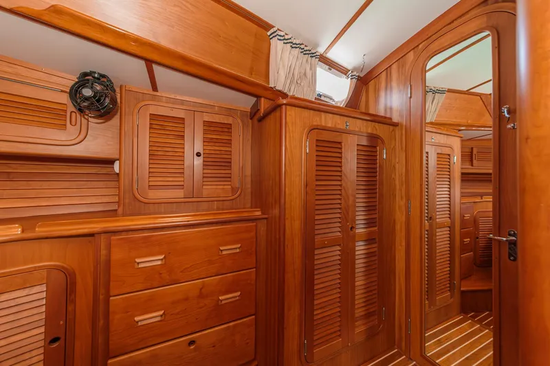 Slide: The Image of Interior of 1998 Hinckley Sou'wester 52 yacht with elegant wooden cabinetry and storage. - 67
