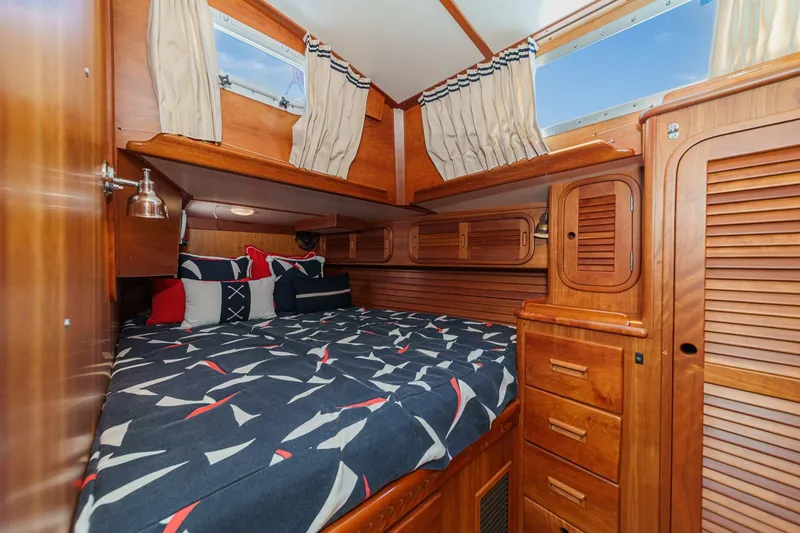 Slide: The Image of Cozy cabin interior of 1998 Hinckley Sou'wester 52 sailboat with nautical-themed bedding. - 72