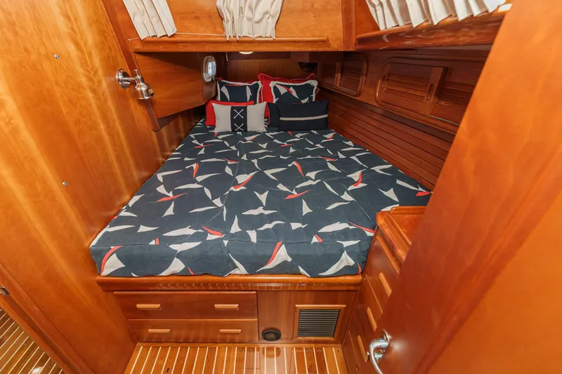 Slide: The Image of Luxurious cabin interior of 1998 Hinckley Sou'wester 52 yacht with patterned bedding. - 73