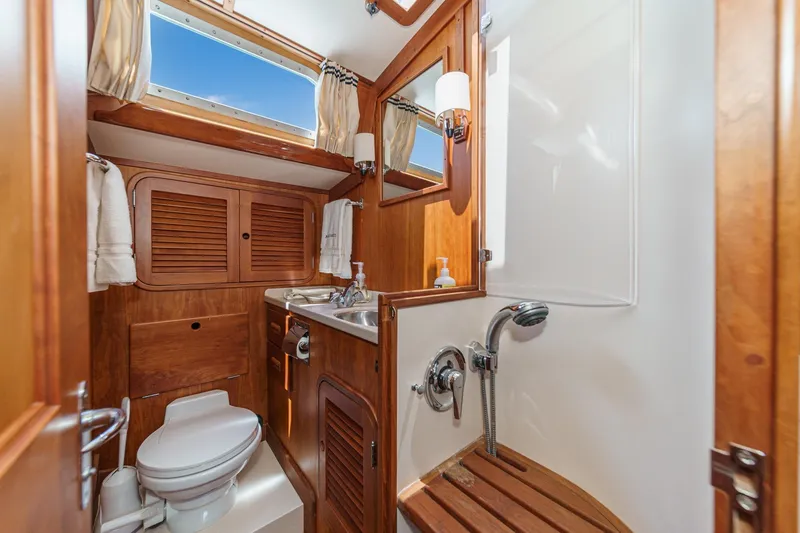 Slide: The Image of Luxurious 1998 Hinckley Sou'wester 52 yacht bathroom with wooden cabinetry and modern fixtures. - 74