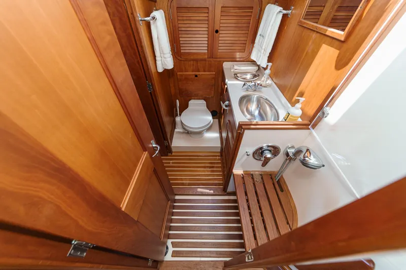 Slide: The Image of Luxurious wooden bathroom interior of 1998 Hinckley Sou'wester 52 yacht, featuring sink and toilet. - 75