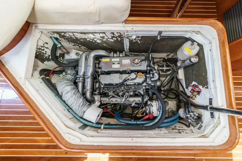 Slide: The Image of Engine compartment of a 1998 Hinckley Sou'wester 52 sailboat, showcasing detailed mechanical components. - 77
