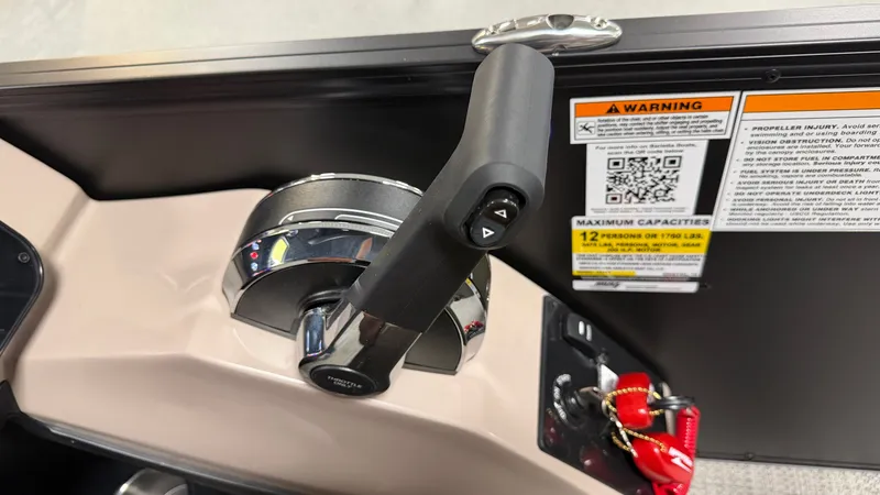 Slide: The Image of Close-up of a boat throttle lever with warning labels and capacity information. - 46