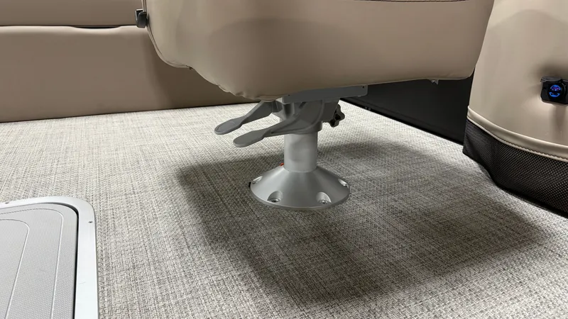 Slide: The Image of A swivel boat seat on textured carpet flooring, surrounded by beige upholstery. - 36