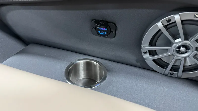 Slide: The Image of Close-up of a speaker and cup holder in a boat. - 25