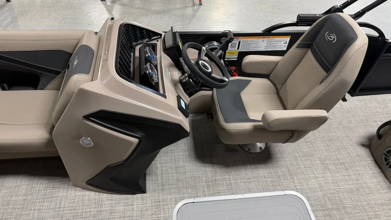 Slide: The Image of The image shows the helm of a Barletta ARIA22UC boat with beige and black seating. - 39