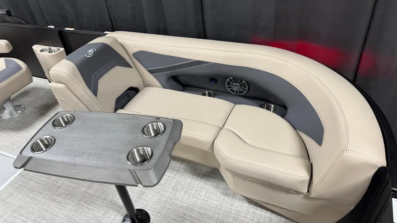 Slide: The Image of The image shows a sleek beige seating area with gray accents and a table with cup holders. - 19