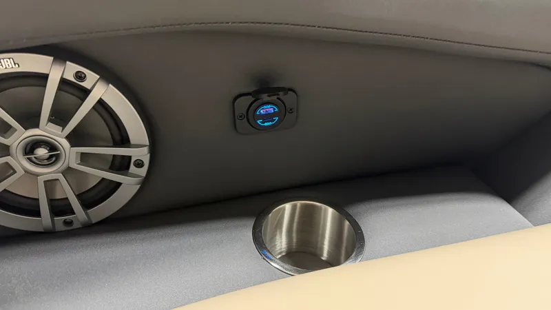 Slide: The Image of Close-up of a speaker and USB port next to a cup holder on a Barletta boat. - 16
