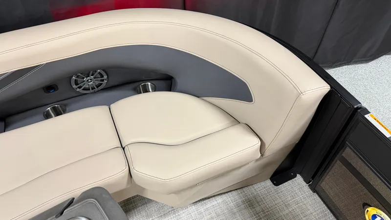 Slide: The Image of The 2027 Barletta ARIA22UC features an elegant cream-colored seating area with a speaker and cup holders. - 21