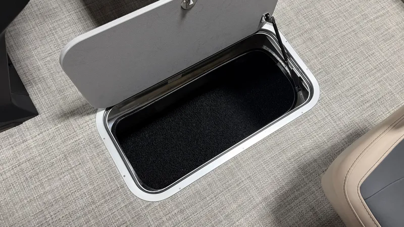 Slide: The Image of An open storage compartment with a black interior on a boat. - 38
