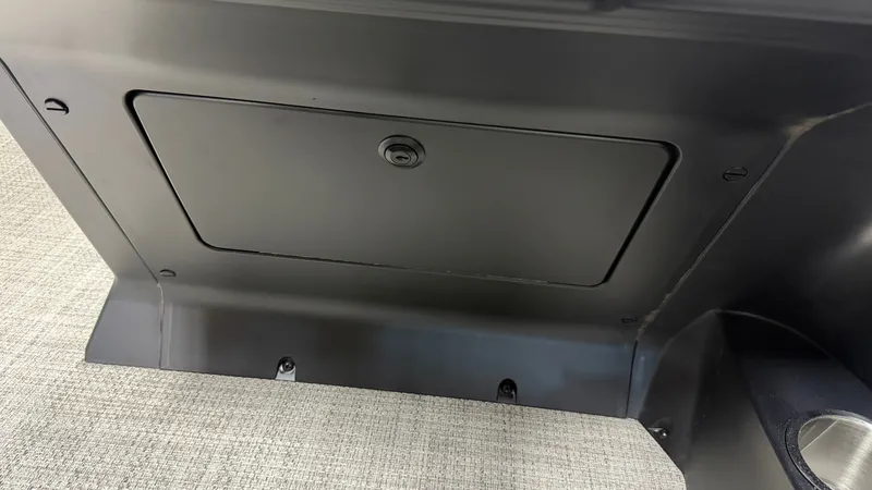 Slide: The Image of A black storage compartment with a small door and lock on a boat. - 48