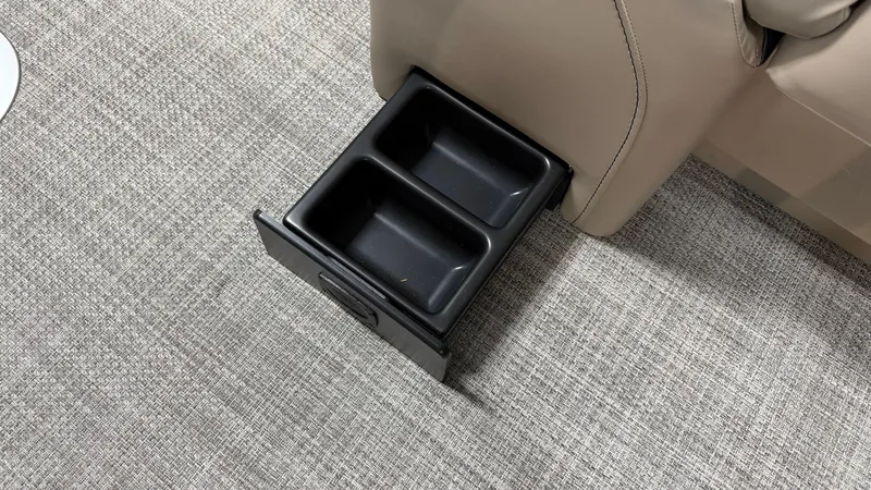 Slide: The Image of A black pull-out cup holder is integrated into the floor of a boat. - 30