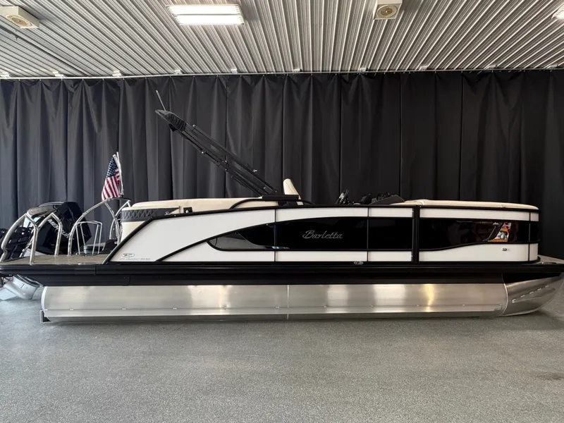 Slide: The Image of A sleek 2027 Barletta LUSSO23QCSS pontoon boat in a showroom. - 1