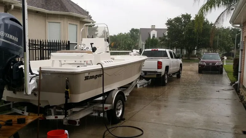 Slide: The Image of 2017 Ranger Bahia 220 boat on trailer in the rain. - 1