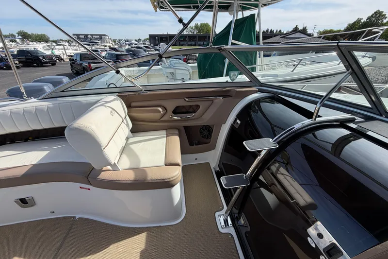 Slide: The Image of Interior of a 2013 Cobalt 273 boat with beige seating and sleek design. - 10