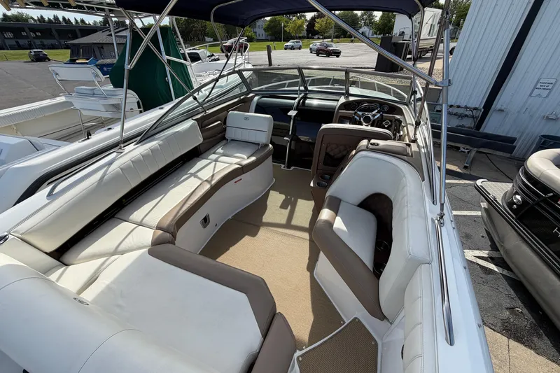 Slide: The Image of 2013 Cobalt 273 boat interior with spacious seating and modern dashboard. - 6