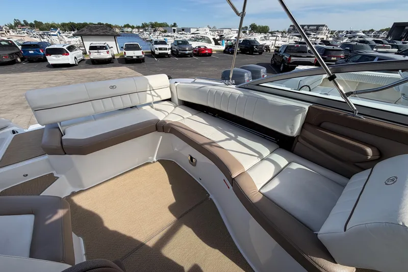 Slide: The Image of Interior of a 2013 Cobalt 273 boat with beige and white seating. - 7
